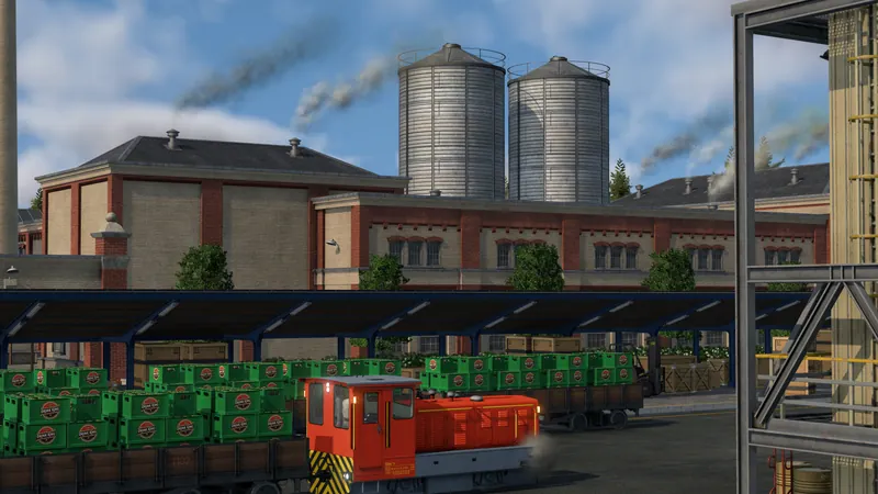 A red cargo tram beside freight loading platforms and industry buildings in Transport Fever 3